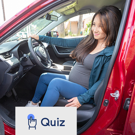 Pregnant woman getting out of her car