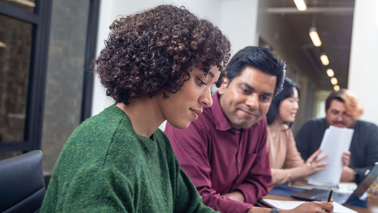 A woman looks at TruStage system provider resources on her phone