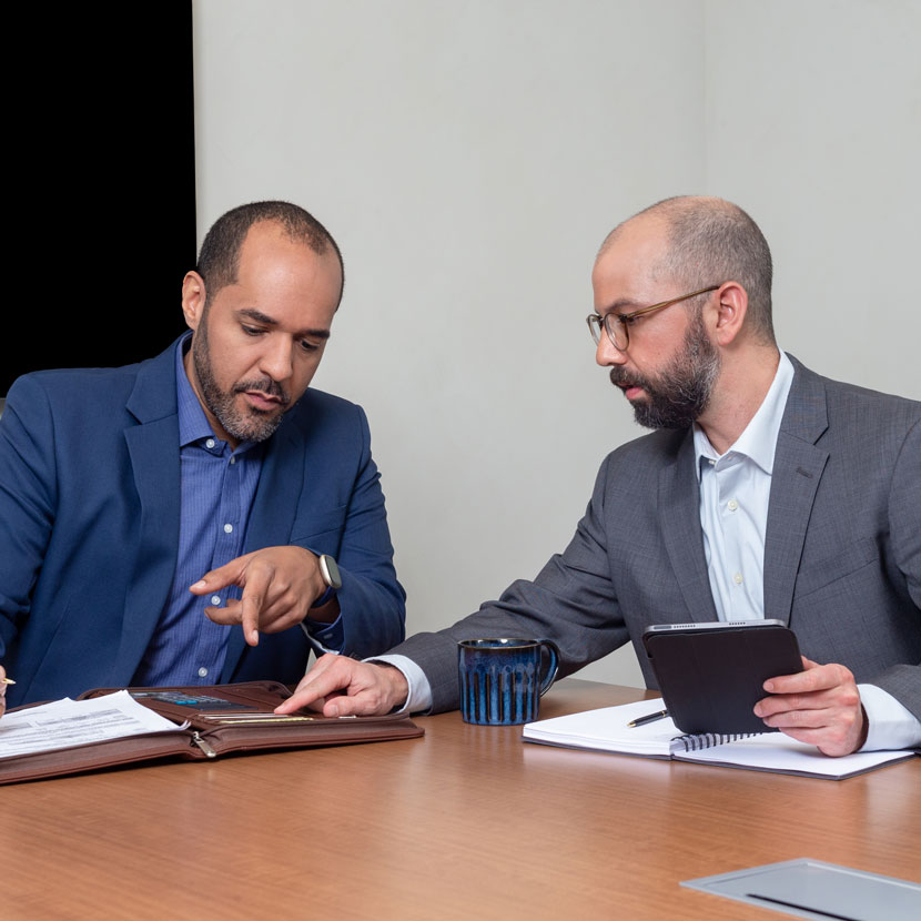 A couple people review TruStage system providers while sitting at a table together