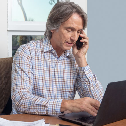 A man looking at his life insurance policy online