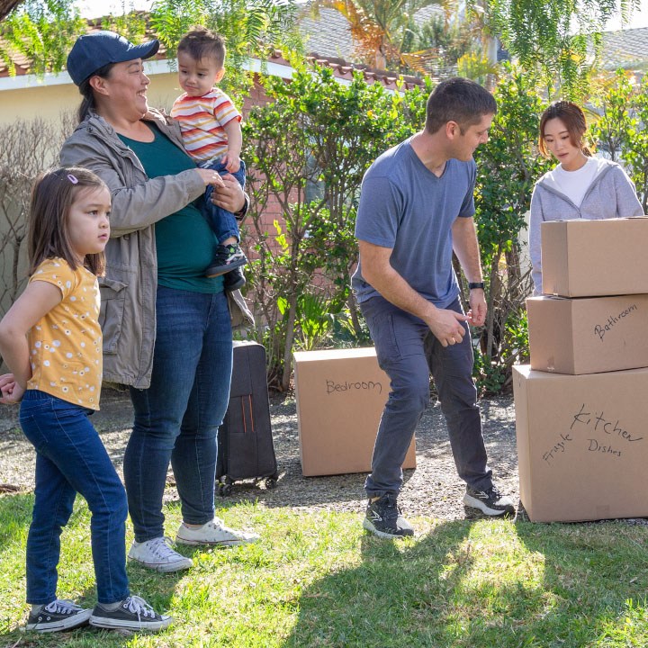 A family organizes boxes on moving day after purchasing renters insurance.