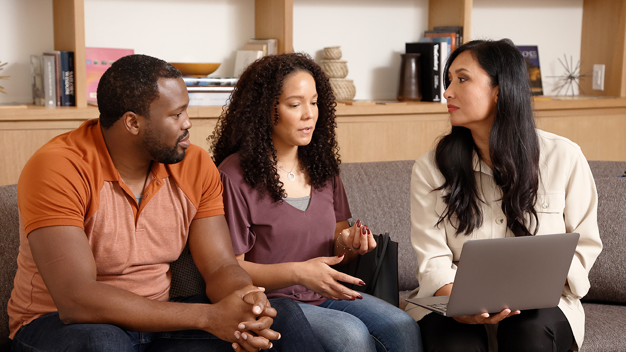 Man and two women discussing business