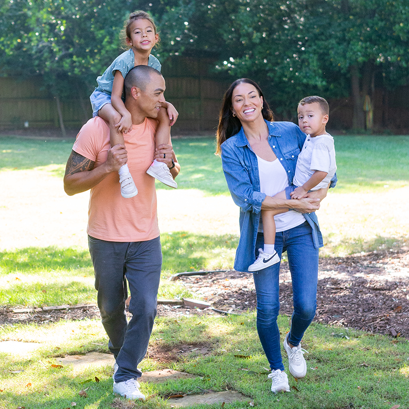 family of four walking through a park