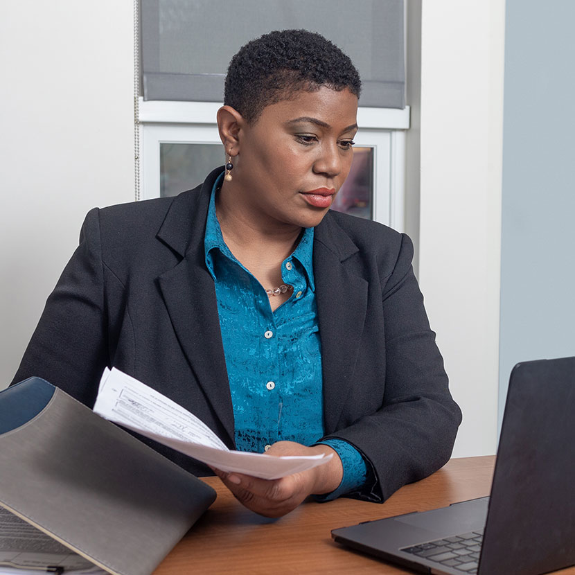 A woman reviews TruStage business protection resources on her laptop