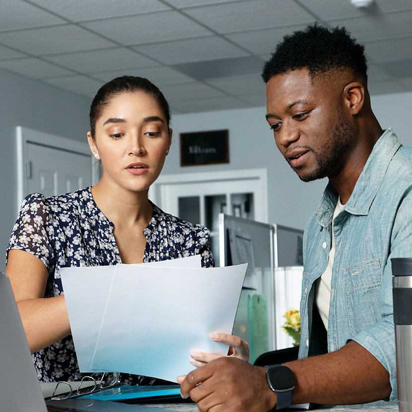 A woman and a man looking at papers together