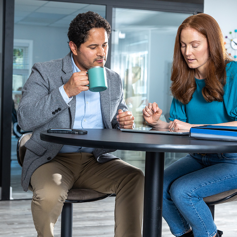 A woman and man work together at a table