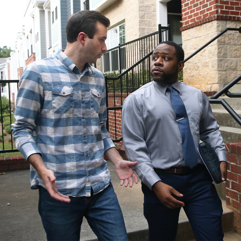 Two men walking together and talking