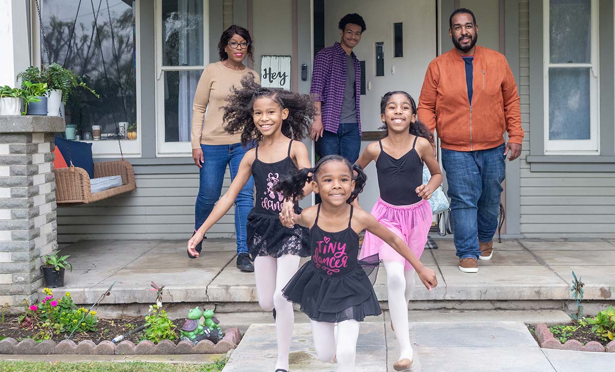 A family walking out the door, feeling confident about their future because of their life insurance policy