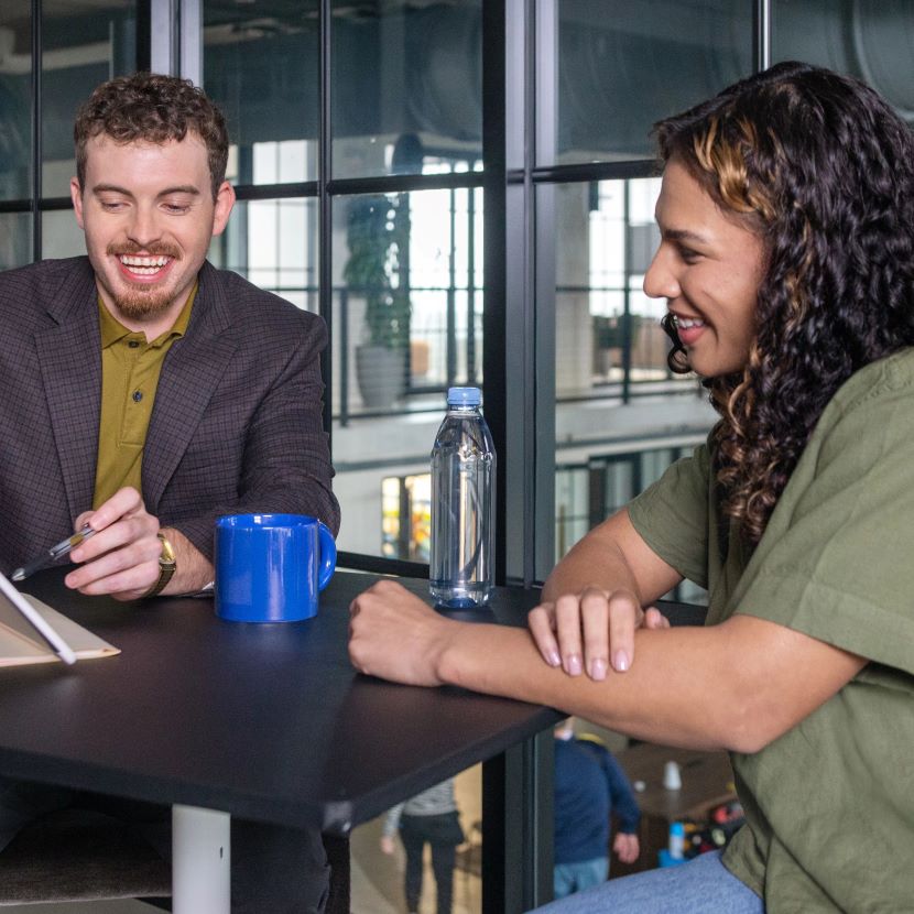 TruStage retirement expert discussing retirement plans with a young woman over coffee.