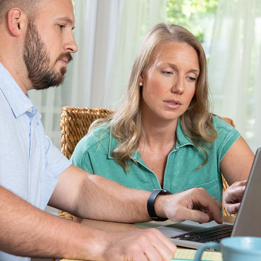 A couple learns about TruStage payment protection while applying for their loan online.