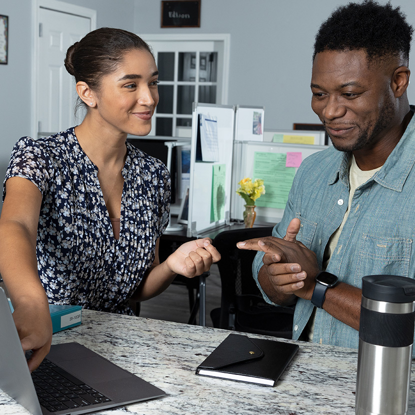 A woman and man viewing the Software as a Service solution on the TruStage Digital Storefront 