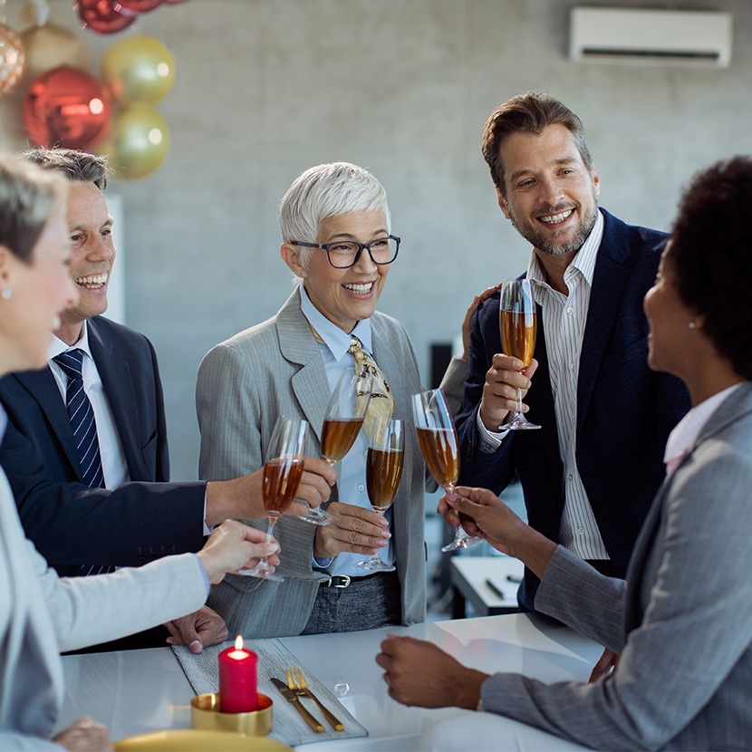 Financial professionals in an office with their clients celebrate the success of TruStage Annuities in 2025.