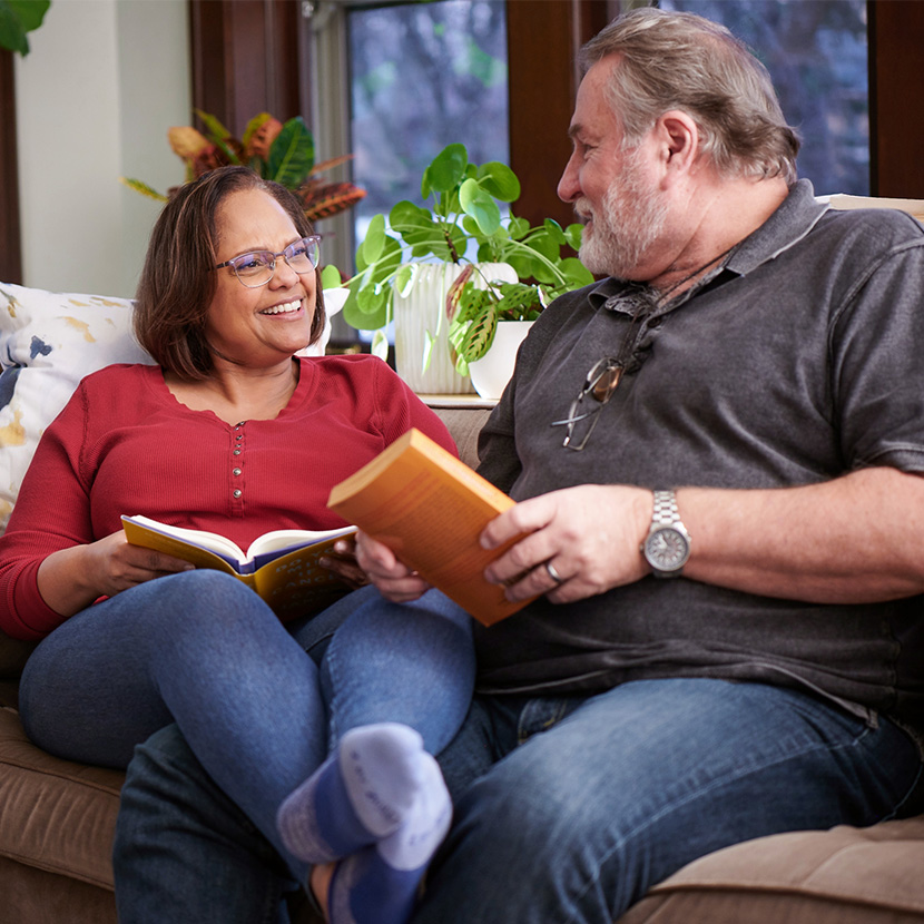 Couple on couch nearing retirement discusses how their better protected with TruStage™ retirement and investment products.