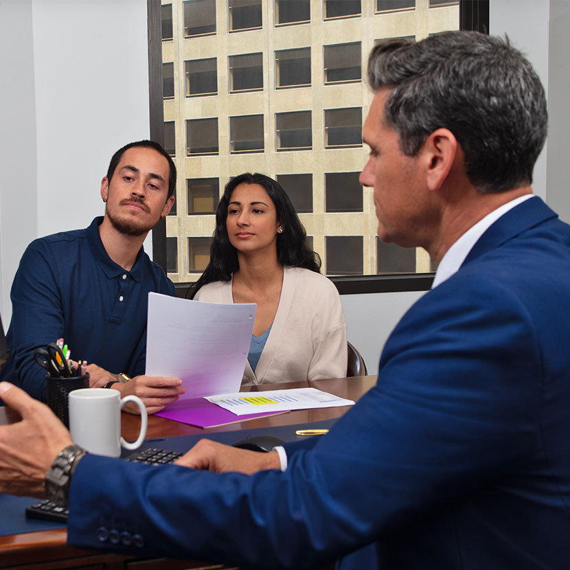 A couple meeting with a businessman to discuss annuities