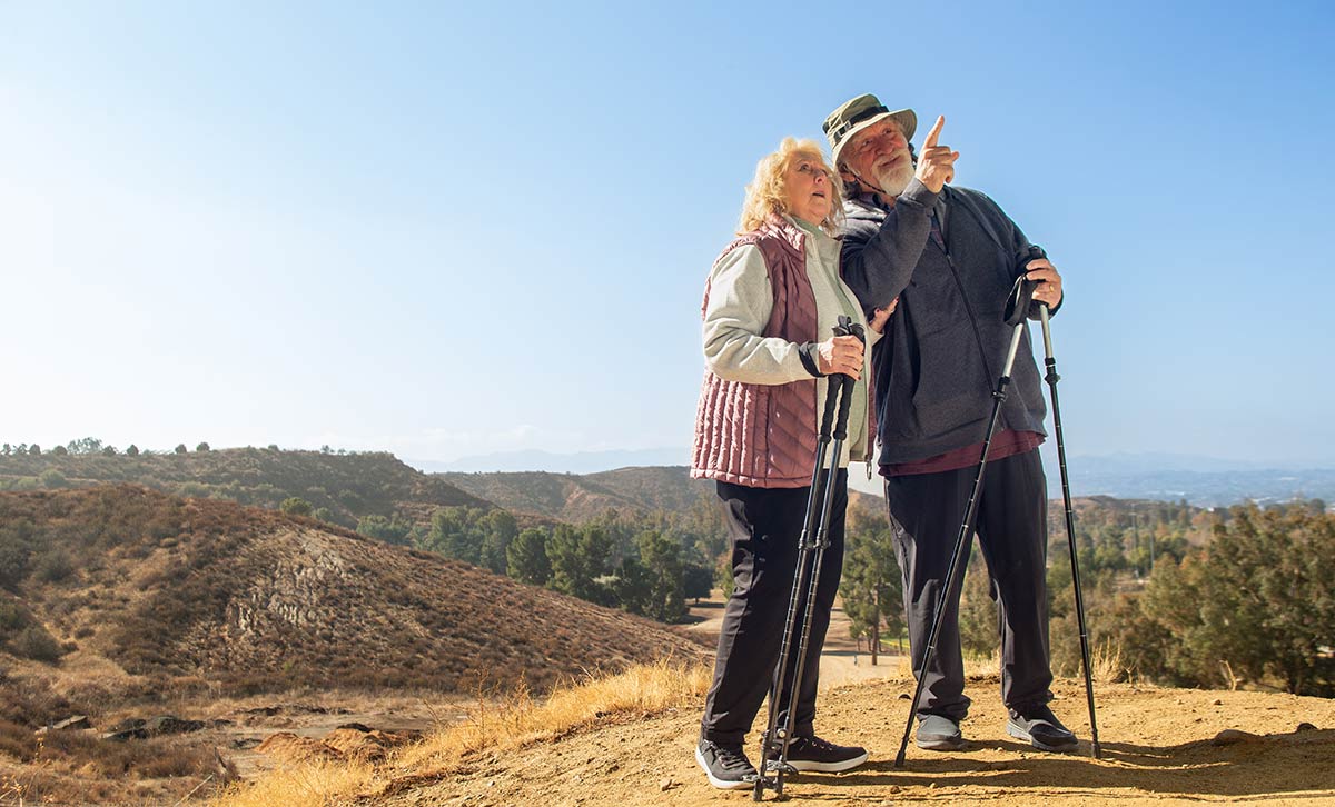 Two people enjoy hiking in retirement because of TruStage fixed annuities