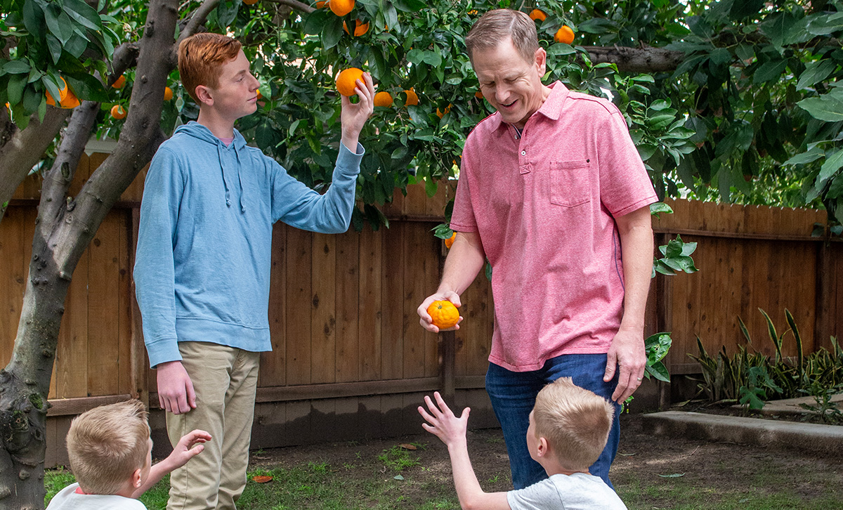 A family picks oranges in their backyard better protected for retirement with MaxProtect Fixed Annuity from TruStage