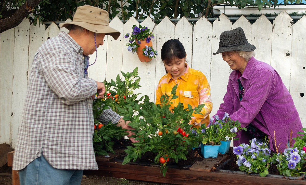 Three retirees tend to their community flower garden are secure in their retirement thanks to TruStage™ ZoneChoice Annuity