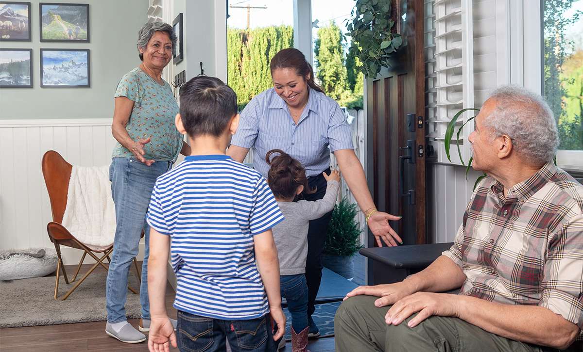 A child and mom hug in front of grandparents that are secure in retirement thanks to ZoneChoice Income Annuity from TruStage™.