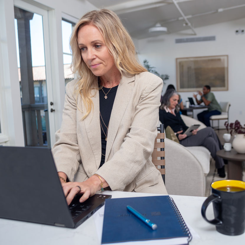 A woman reviews TruStage fidelity bond on her laptop