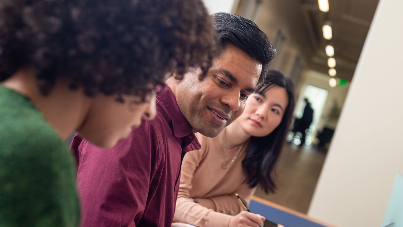 A group of people discuss TruStage cybersecurity protection