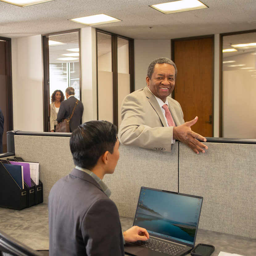 A few people in an office discuss TruStage business solutions