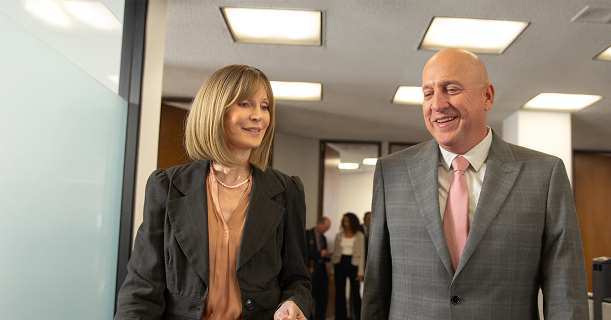 Two people walking and talking about TruStage compliance solutions