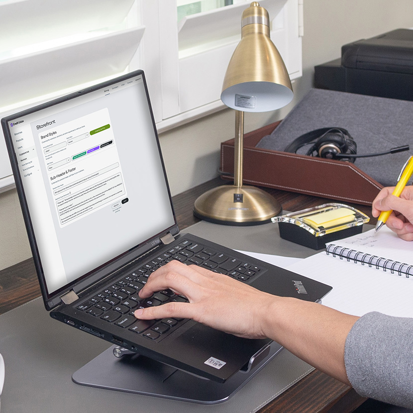 A financial professional uses a laptop to configure their storefront based on the goals of their organization.