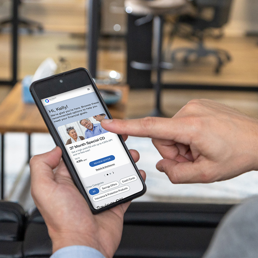 A consumer uses their phone to review a range of deposit products from their financial institution.