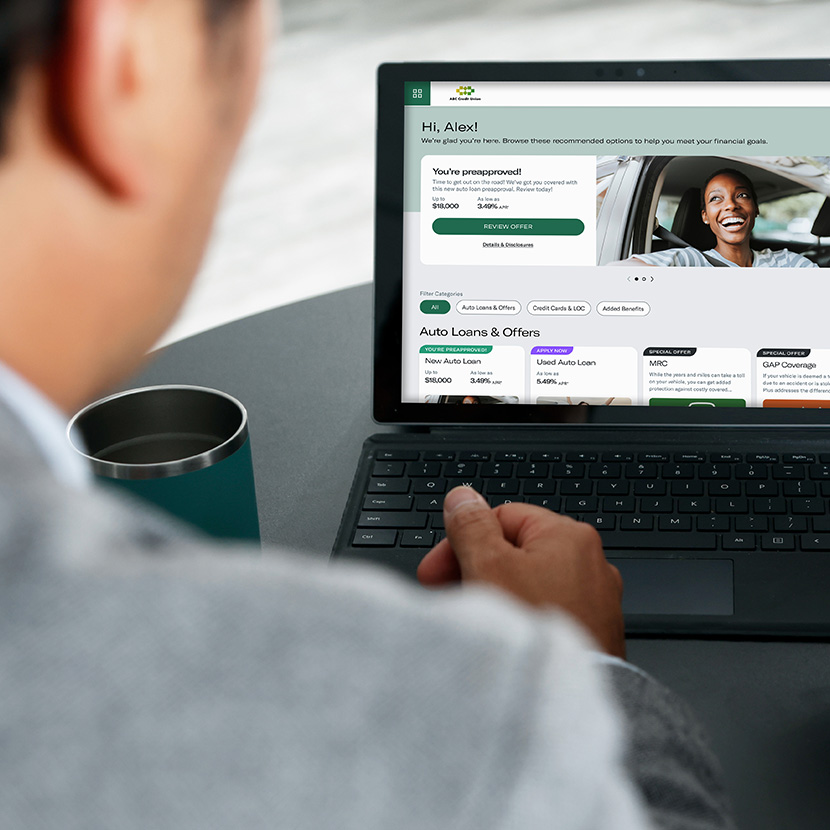 A man using a laptop reviews personalized offers made available through the Digital Storefront.