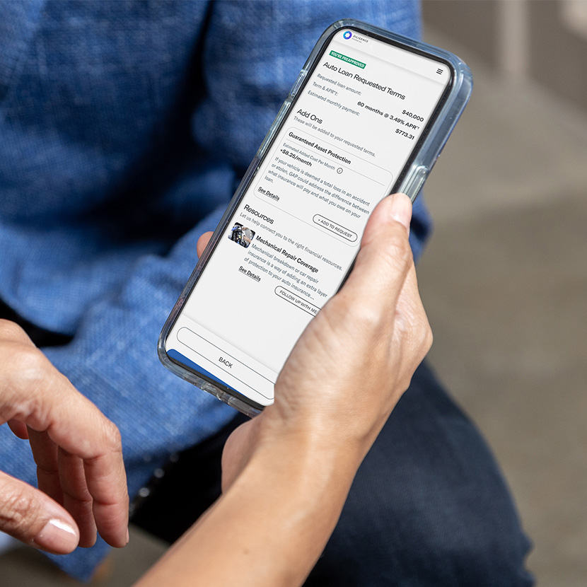 A consumer uses their phone to review additional financial products available to them through the Product + feature.