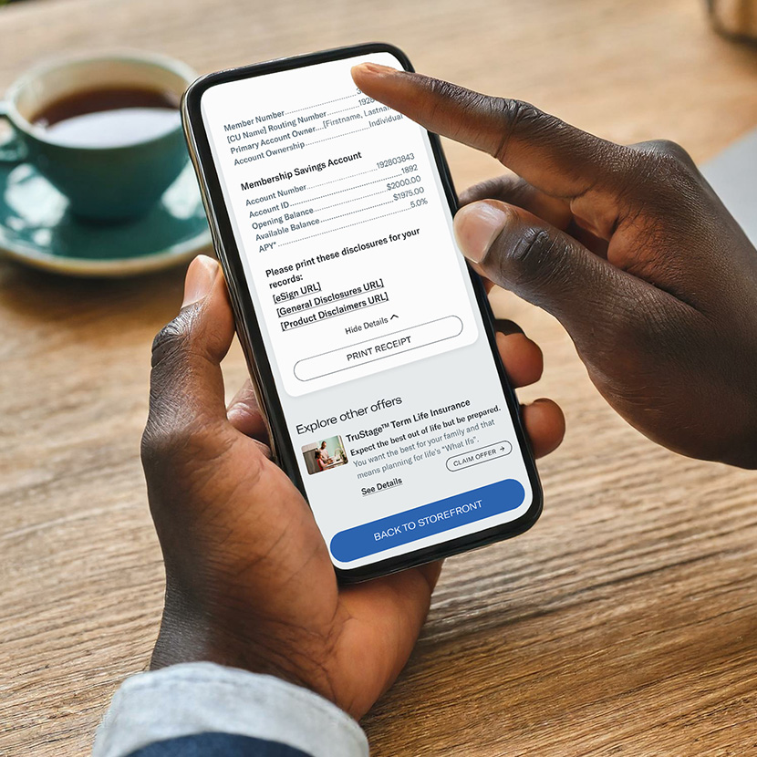 A man scrolls through his phone reviewing a financial product he added through the Digital Storefront.