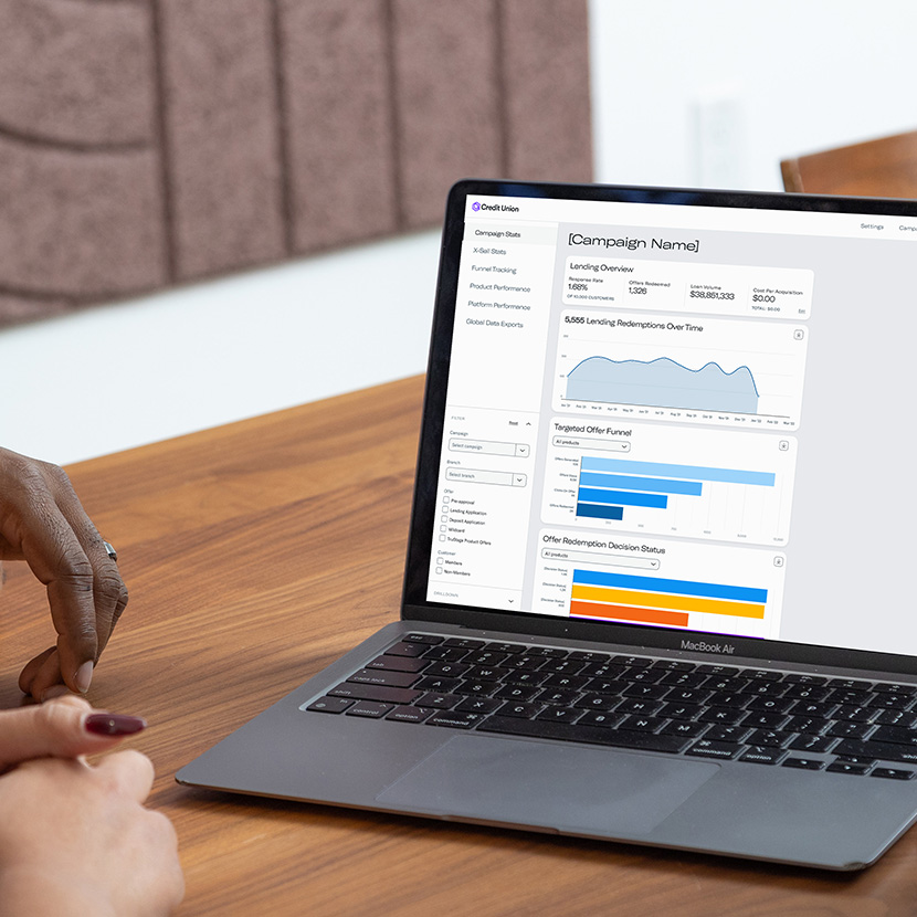 A financial professional reviews analytics on her laptop to improve Digital Storefront campaigns and Product + placements.