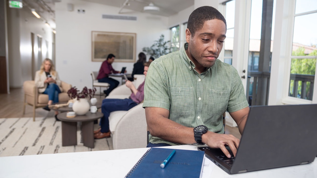 A man researches TruStage credit insurance on his laptop