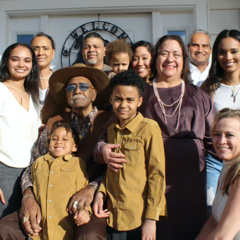 Large family standing in front of a door