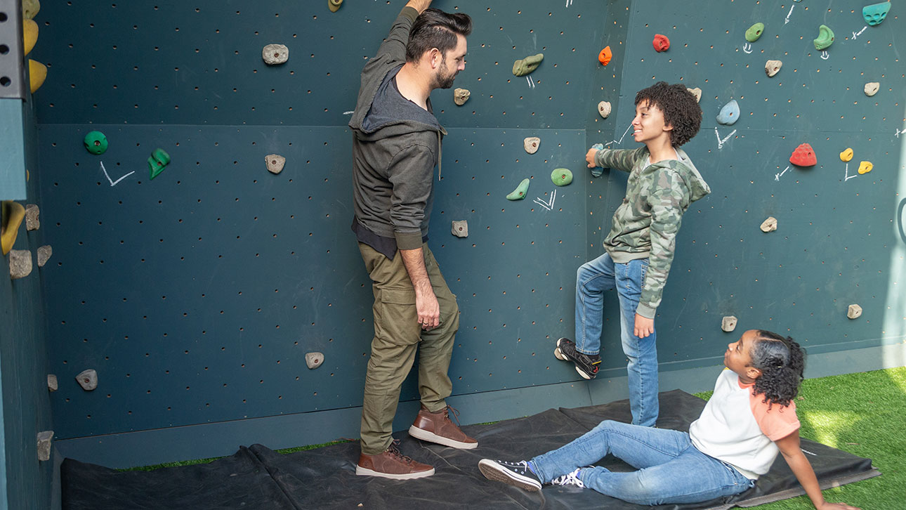 A group of people talk about TruStage while rock climbing