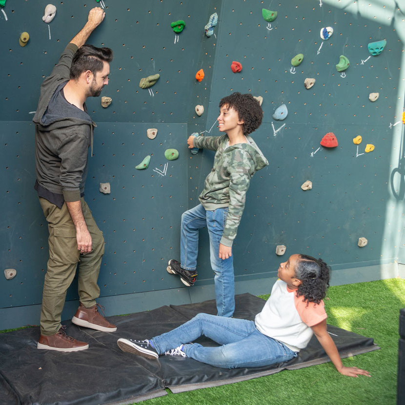 A group of people talk about TruStage while rock climbing