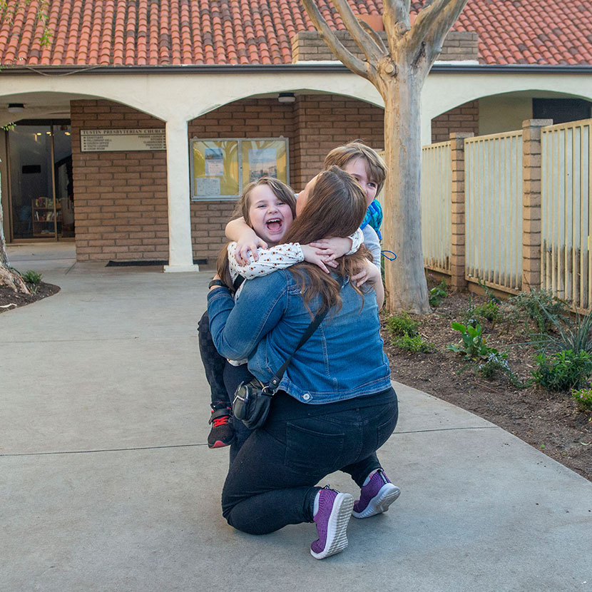 A mother hugs her two children confident they are protected by TruStage Term Life Insurance