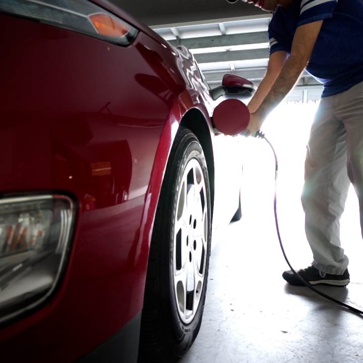 A man charges his electric vehicle in his garage.