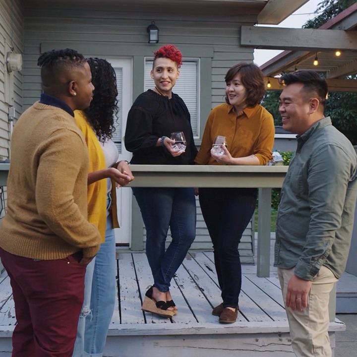 A group of friends discuss life insurance in the backyard.