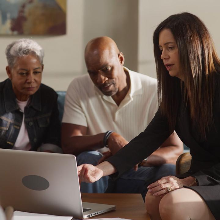 A financial professional sits with a married couple and explains how life insurance rates are determined.