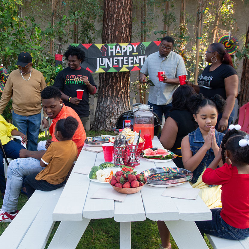 A family protected by TruStage whole life insurance celebrates together at a picnic