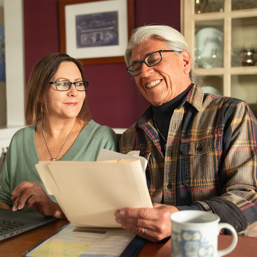 A man and a woman discussing their retirement portfolio. 