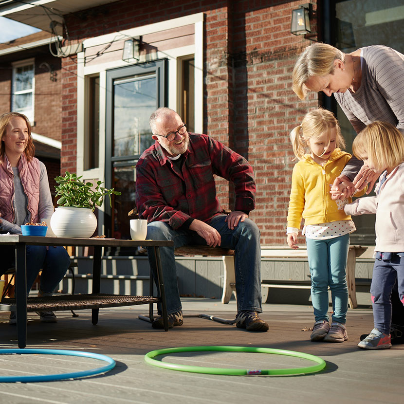 Grandparents playing with grandkids outside are secure in their retirement, thanks in part to TruStage™