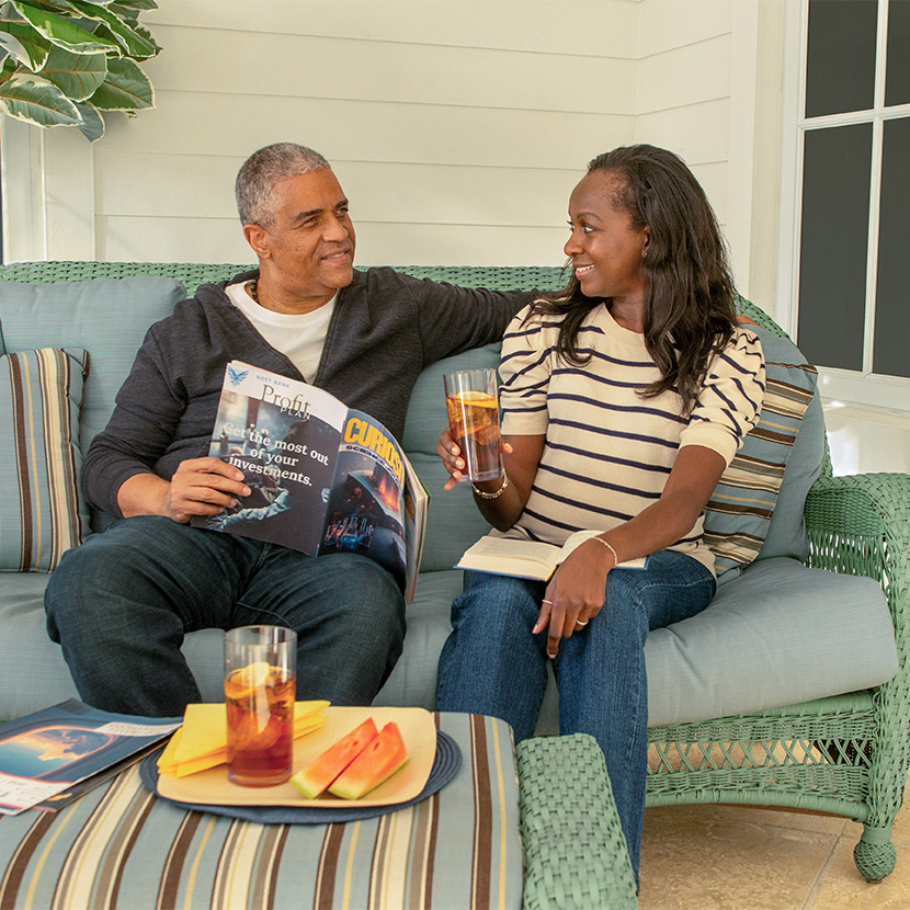 A couple sitting on a couch discusses the benefits of working with TruStage®